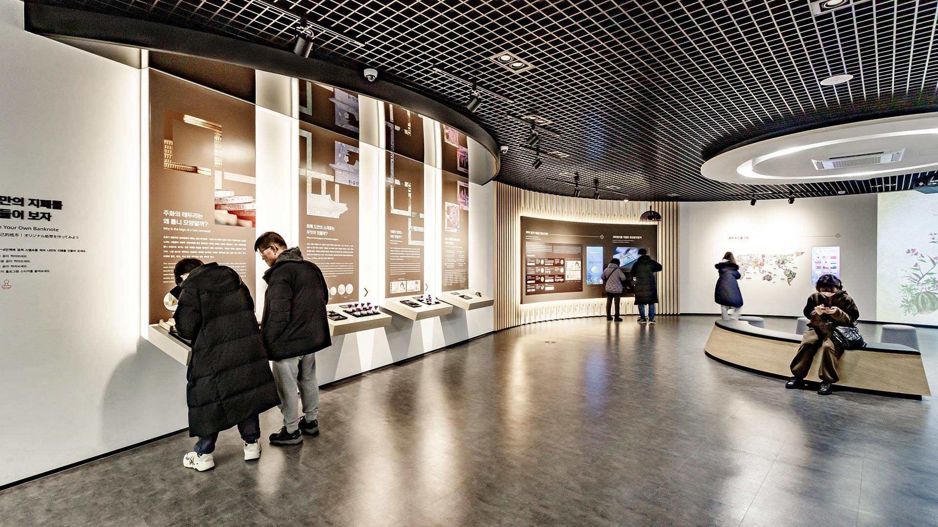 People viewing indoor exhibits at Gangneung Money Museum 02